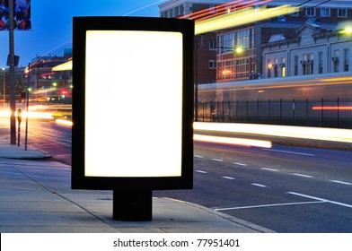 Blank Billboard On City Street At Night. Outdoor Advertising