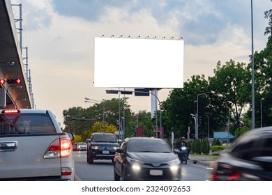 A blank billboard on one of Thailand's streets, a blank billboard with copy space for text or content, mockup of a blank billboard in a big city, evening scene. Space for your ad. - Shutterstock ID 2324092653