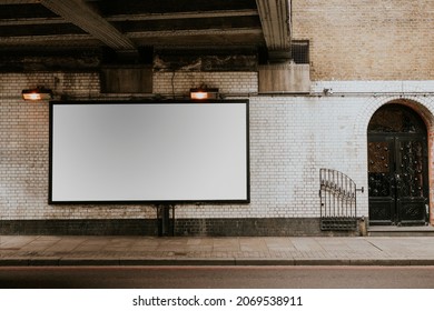 Blank billboard on a white wall - Shutterstock ID 2069538911