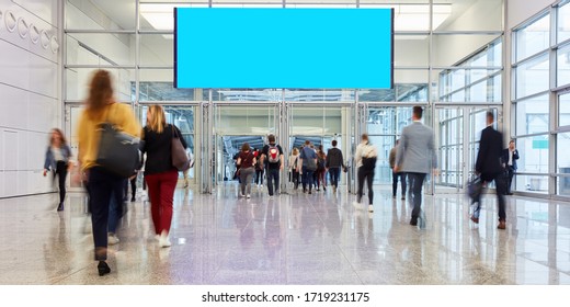 Blank billboard in progress of a trade fair or event over many people - Shutterstock ID 1719231175