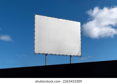 Blank billboard sign mockup in the urban environment, clear sky, empty space to display your advertising or branding campaign - Shutterstock ID 2265453309