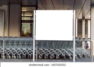 Blank billboard in a supermarket, next to shopping carts