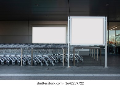 Blank billboard in a supermarket, next to shopping carts