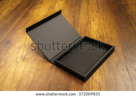 Blank black box mock up on wood background