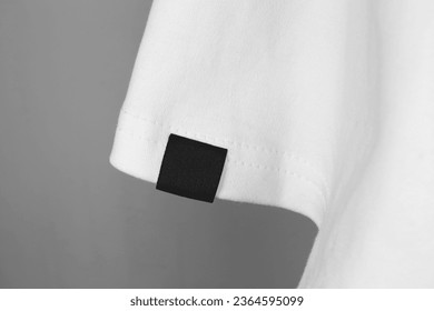 blank black color clothing label on white t shirt sleeve