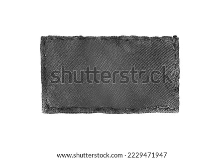 Blank black fabric clothing label patch isolated over white