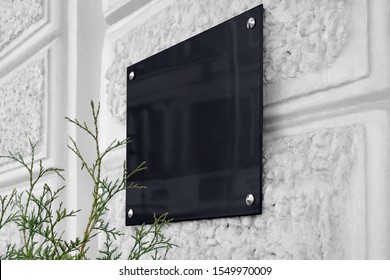 Blank Black Glass Signboard On Gray Textured Wall Mockup. Empty Hanging Plexiglas Nameplate Mock Up. Clear Dark Namesign On Wal For Corporate Or Store Title Mokcup Template.