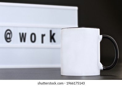 Blank black handle mug with work message led light box on black background. 11 oz mug mock up