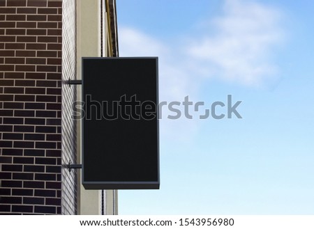 Blank black light box mockup on brick wall, sky background. Empty mart or cafe signplate mock up on brick edifice. Clear hanging panel for advert on businesscenter mokcup template.