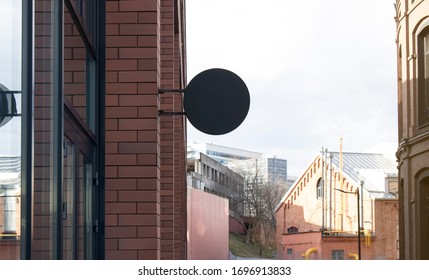 Blank Black Outdoor Round Sign Mockup Brick Wall Mounted. Empty Circle Display For Beauty Saloon Or Barbershop Logo Mock Up. Clear Hanging Signage For Store Info Mokcup Template.