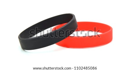 Blank black, red rubber wristband mockup on hand, isolated. Clear sweat band mock up design. Sport sweatband template wear on wrist arm. Silicone fashion round social bracelet wear on hand. Unity band
