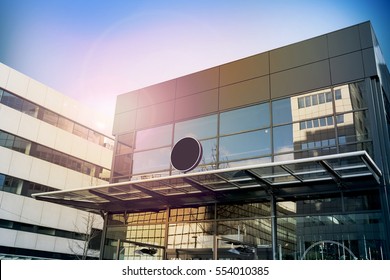 Blank Black Round Signage Mockup, Modern Business Building. Circle Sign Board Mock Up Hanging On Glass Roof Of The Store Entrance. Street Advertising Banner Design Template