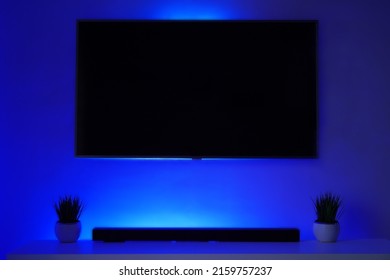 Blank BLACK TV Screen In BLUE Bright Mockup, Front View. Empty Telly LED Display In Living Room Mock Up. Clear Panel Monitor Ready To Use In Powerpoint Presentation. 