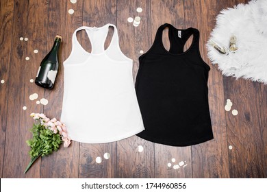Blank black and white racerback shirts on dark background with party props, bachelorette party apparel mockup
