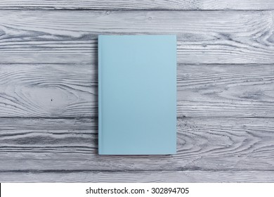 Blank Book Cover On Textured Wood Background. Copy Space