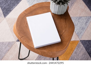 blank book mockup on coffee table with decorations and colorful rug