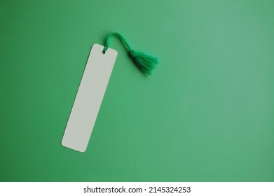 A blank bookmark on green paper background