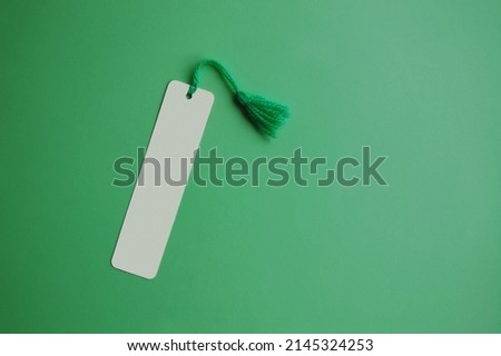 A blank bookmark on green paper background