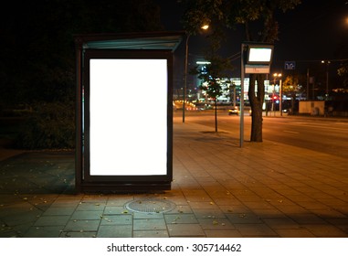 Blank Bus Stop Advertising Billboard In The City At Night.