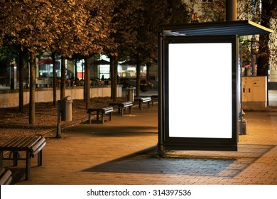 Blank Bus Stop Advertising Billboard In The City At Night.