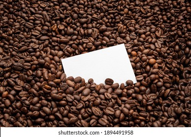 Blank business card mockup on coffee seeds background,  coffee packaging mockup with empty space to display your branding design.