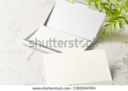 Blank business card on wooden table, business concept.