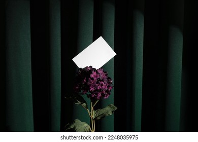 Blank business cards mockup template on a green fabric curtains background, in a velvet flower. Real photo, the isolated surface to place your design. 