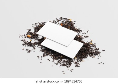 Blank business cards in the pile of tea on a white background, packaging mockup with empty space to display your branding design.