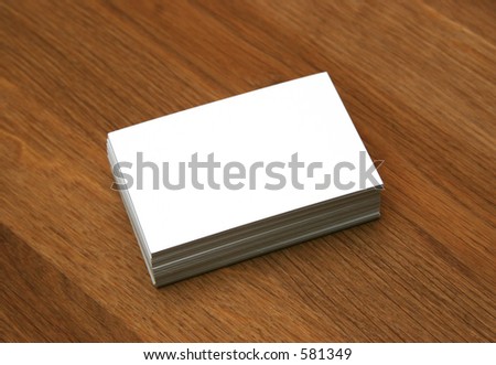 Blank business cards stacked up on a desk - insert your own design