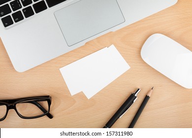 Blank business cards with supplies on wooden office table - Powered by Shutterstock