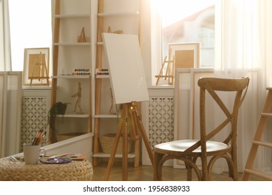 Blank canvas on easel in art studio - Powered by Shutterstock