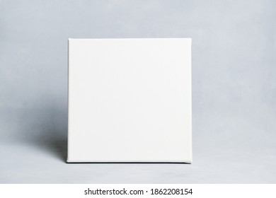 Blank Canvas On Grey Background. Square Mockup Poster Frame.