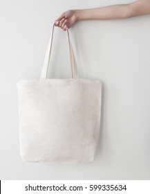 Blank Canvas Tote Bag, Design Mockup With Hand. Handmade Shopping Bags.