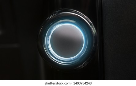 Blank car ignition button with blue light on black background, copy space