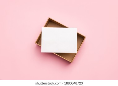 Blank Card With Craft Paper Box On Pink Background. Copy Space, Space For Text. Mockup Template For Design.