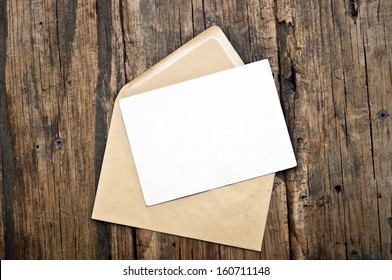 Blank Card And Envelope On Old Wooden Background