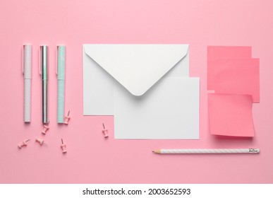 Blank Card With Envelope And Stationery On Color Background