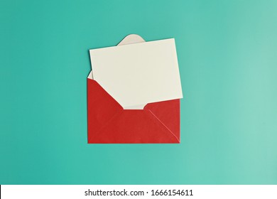 Blank Card And Red Envelope On Green Background. 