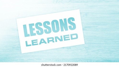 Blank Card With Text Lessons Learned On Wooden Background. Business Concept.