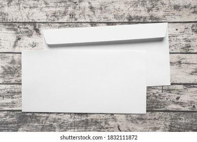 Blank Card And White Envelope On Desk