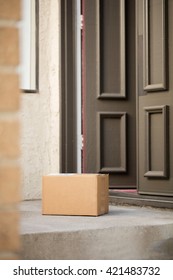 A Blank Carton Box Is Delivered At Front Door