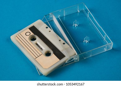 Blank Cassette Tape Box On Blue Background. Vintage Cassette Tape Case With Retro Cassette Mockup. Plastic Analog Magnetic Clear Packaging Template. Mixtape Box Open 