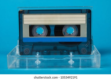 Blank Cassette Tape Box On Blue Background. Vintage Cassette Tape Case With Retro Cassette Mockup. Plastic Analog Magnetic Clear Packaging Template. Mixtape Box Open 