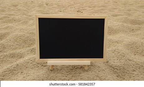 Blank chalkboard on the beach

