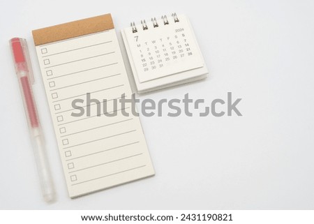 Blank Check list or Empty small notepad with checkbox and Simple desk calendar for JULY 2024. Blank checklist for text. Copy Space.