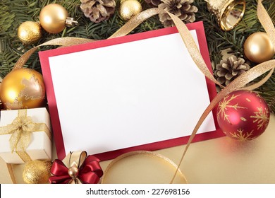 Blank Christmas card or invitation with red envelope surrounded by ribbons and decorations. Space for copy.  - Powered by Shutterstock