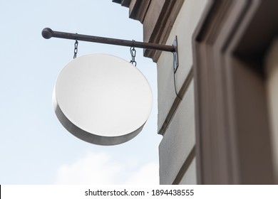 Blank Circle Sign Mockup In The Urban Environment, On The Facade, Empty Space To Display Your Store Sign Or Logo