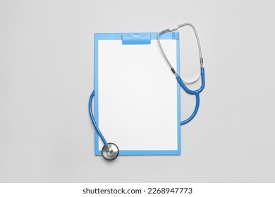 Blank clipboard with stethoscope on grey background. World Health Day - Powered by Shutterstock