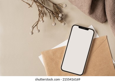 Blank Clipping Path Screen Mobile Phone With Mockup Copy Space And Dry Floral Branch And Blanket Cloth On Neutral Beige Background. Minimal Aesthetic Business Brand Template. Flat Lay, Top View