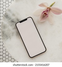 Blank Clipping Path Screen Mobile Phone, Pink Flower On Marble Stone Table On Mosaic Tile Background. Aesthetic Template With Mockup Space. Flat Lay, Top View